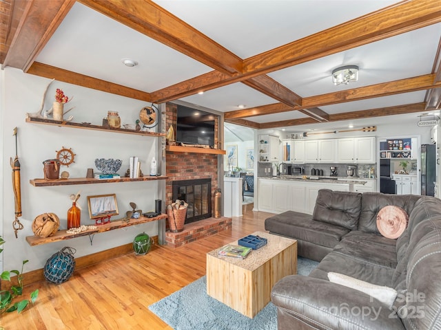 95 Harmon Ave, Lake Junaluska, NC 28745 - living room with light wood-style flooring, beam ceiling, coffered ceiling, a brick fireplace, and baseboards