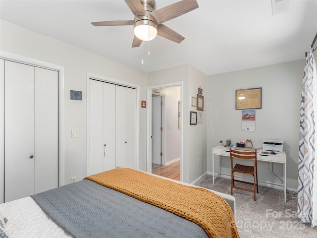 95 Harmon Ave, Lake Junaluska, NC 28745 - bedroom featuring two closets, light colored carpet, baseboards, and a ceiling fan