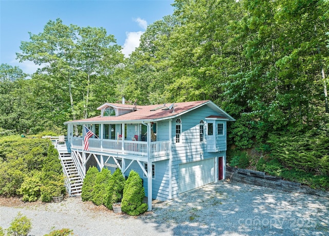 724 Pless Underwood Rd, Maggie Valley, NC 28751 - view of front of property with stairs, a porch, a wooded view, driveway, and a garage
