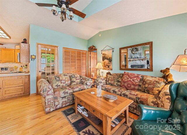 724 Pless Underwood Rd, Maggie Valley, NC 28751 - living room with light wood-style floors, vaulted ceiling, and a ceiling fan
