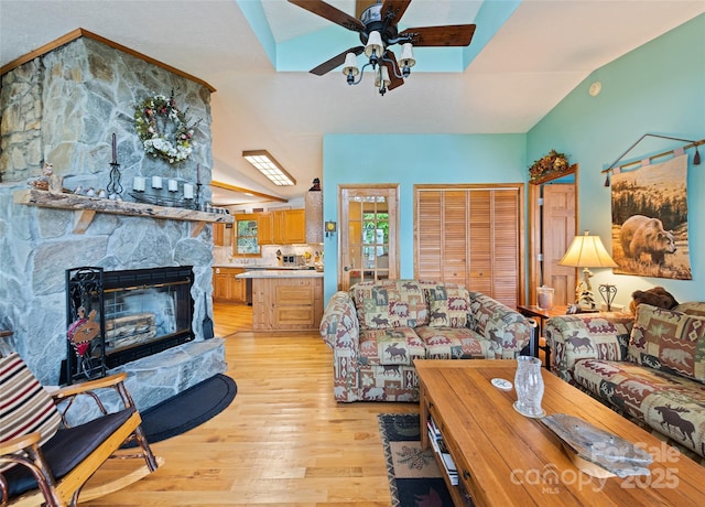 724 Pless Underwood Rd, Maggie Valley, NC 28751 - living room featuring ceiling fan, light wood-style floors, a fireplace, and vaulted ceiling