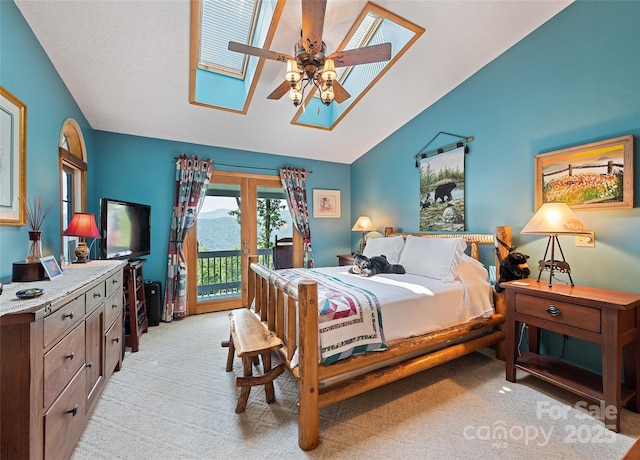724 Pless Underwood Rd, Maggie Valley, NC 28751 - bedroom with access to outside, a skylight, lofted ceiling, light colored carpet, and ceiling fan