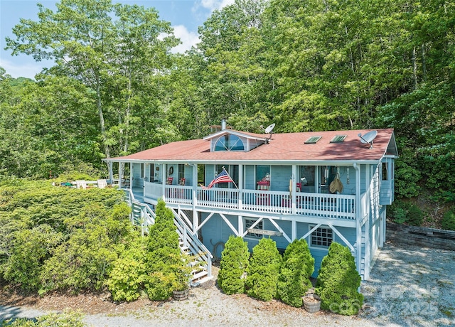 724 Pless Underwood Rd, Maggie Valley, NC 28751 - view of front of house with a porch, a wooded view, and stairs