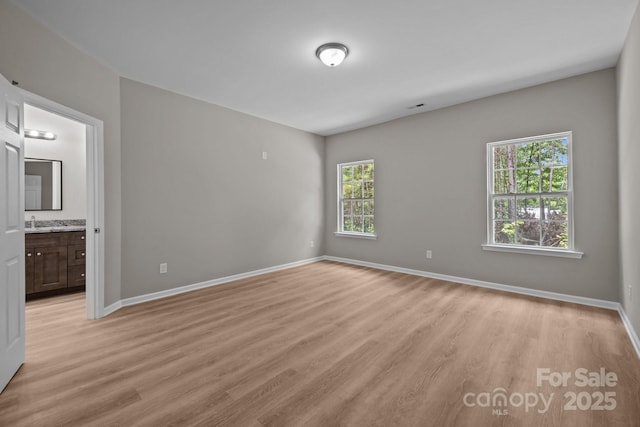 130 Aurora Blvd, Matthews, NC 28105 - unfurnished bedroom with light wood finished floors and connected bathroom