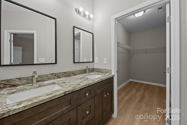 130 Aurora Blvd, Matthews, NC 28105 - bathroom with wood finished floors, double vanity, and a spacious closet
