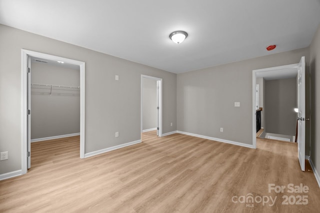 130 Aurora Blvd, Matthews, NC 28105 - unfurnished bedroom featuring light wood-style floors, a spacious closet, and a closet