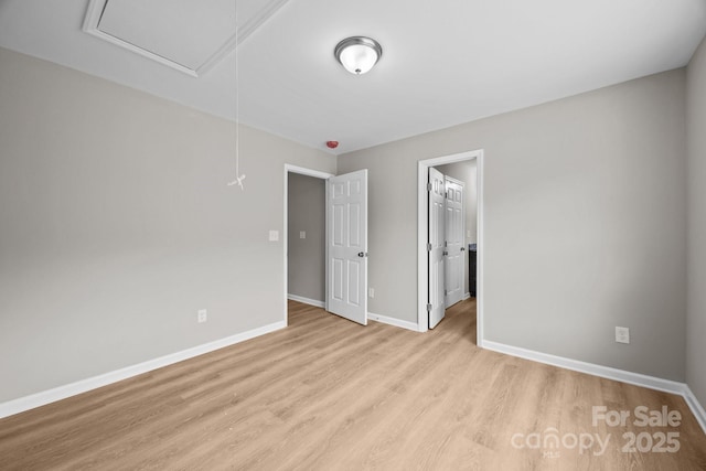 130 Aurora Blvd, Matthews, NC 28105 - unfurnished bedroom featuring attic access and light wood-type flooring