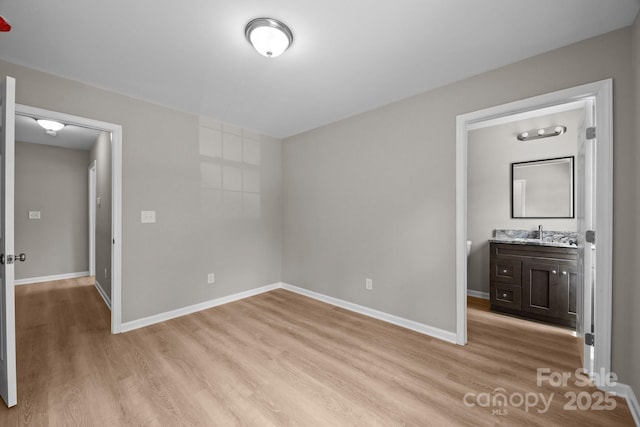 130 Aurora Blvd, Matthews, NC 28105 - unfurnished bedroom with light wood finished floors and connected bathroom