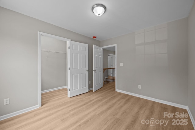 130 Aurora Blvd, Matthews, NC 28105 - unfurnished bedroom featuring wood finished floors, a closet, and a walk in closet