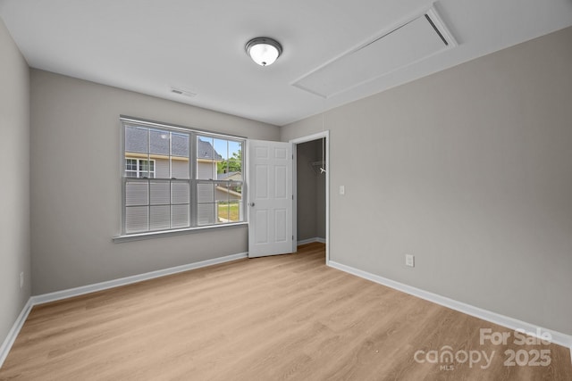 130 Aurora Blvd, Matthews, NC 28105 - unfurnished bedroom with wood finished floors and attic access
