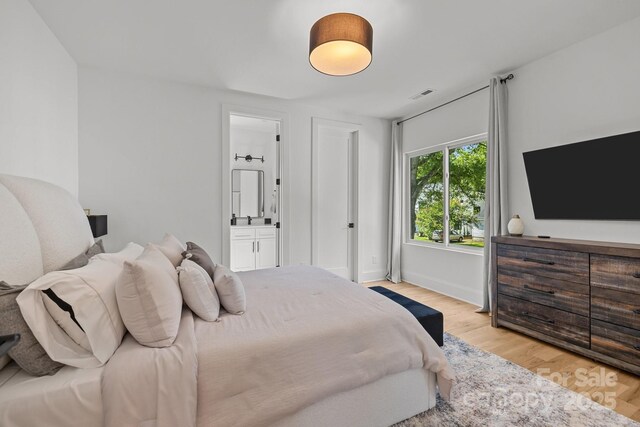 2121 Laburnum Ave, Charlotte, NC 28205 - bedroom with light wood-type flooring and ensuite bath