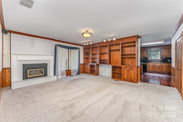 220 Blackberry Trl, Concord, NC 28027 - unfurnished living room featuring dark carpet, a brick fireplace, and crown molding