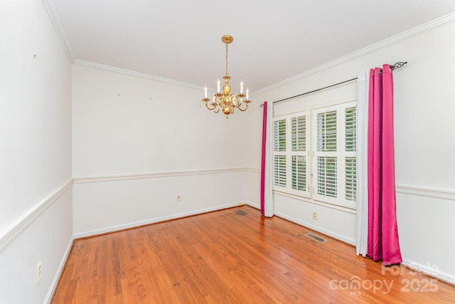 220 Blackberry Trl, Concord, NC 28027 - spare room with a chandelier, wood finished floors, crown molding, and baseboards