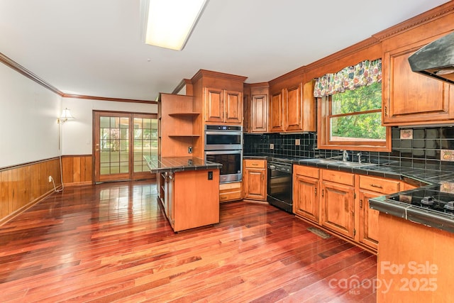 220 Blackberry Trl, Concord, NC 28027 - kitchen with black appliances, open shelves, wood finished floors, healthy amount of natural light, and wainscoting