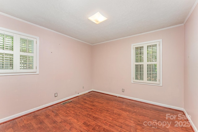 220 Blackberry Trl, Concord, NC 28027 - empty room with wood finished floors, ornamental molding, plenty of natural light, baseboards, and a textured ceiling