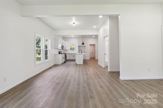 113 Woodside Ave, Gastonia, NC 28054 - unfurnished living room with light wood-type flooring and recessed lighting