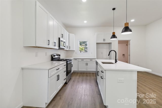 113 Woodside Ave, Gastonia, NC 28054 - kitchen featuring stainless steel appliances, wood finished floors, a kitchen island with sink, white cabinets, and recessed lighting
