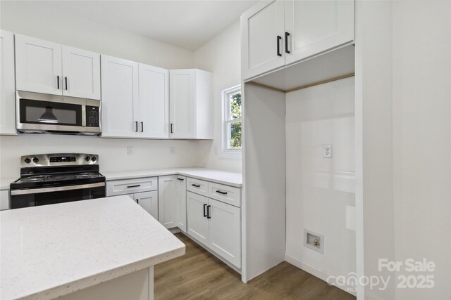 113 Woodside Ave, Gastonia, NC 28054 - kitchen featuring appliances with stainless steel finishes, light wood-style floors, white cabinets, and light stone countertops