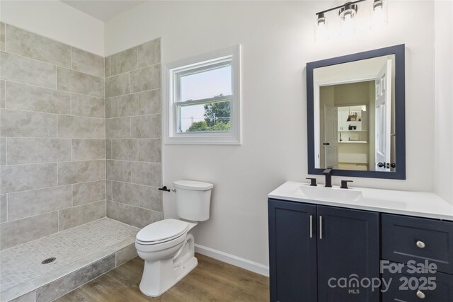 113 Woodside Ave, Gastonia, NC 28054 - bathroom with vanity, wood finished floors, and a tile shower