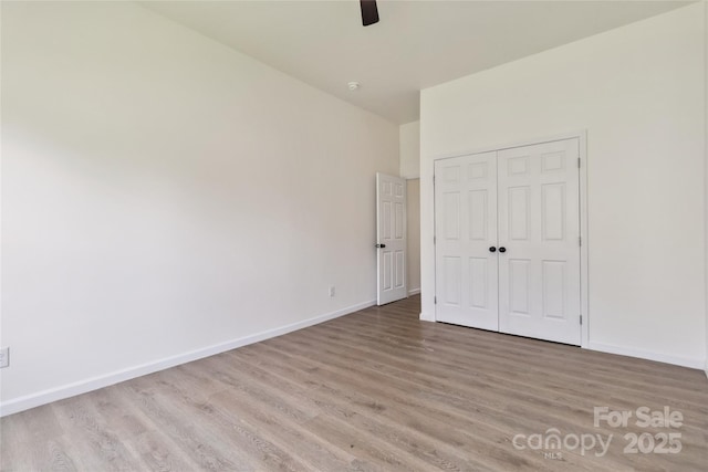 113 Woodside Ave, Gastonia, NC 28054 - unfurnished bedroom featuring light wood-style flooring, a closet, and a ceiling fan