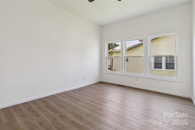 113 Woodside Ave, Gastonia, NC 28054 - unfurnished room with wood finished floors and a ceiling fan