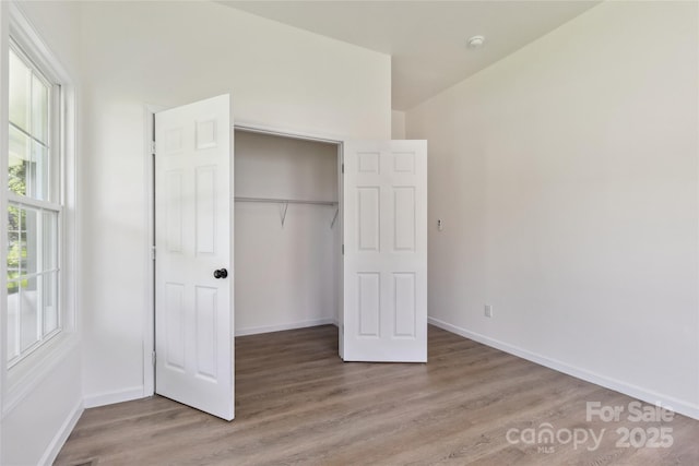 113 Woodside Ave, Gastonia, NC 28054 - unfurnished bedroom with wood finished floors and a closet