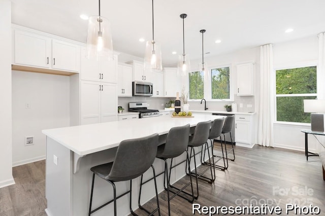 24578 Blue Heron Cir Unit 407, Lancaster, SC 29720 - kitchen with appliances with stainless steel finishes, white cabinetry, a sink, a center island, and light countertops