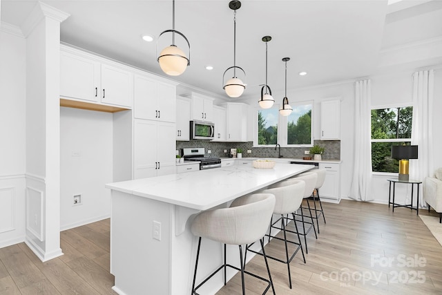 24578 Blue Heron Cir Unit 407, Lancaster, SC 29720 - kitchen featuring appliances with stainless steel finishes, light wood-style floors, a center island, tasteful backsplash, and recessed lighting