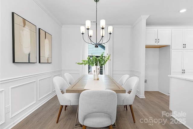 24578 Blue Heron Cir Unit 407, Lancaster, SC 29720 - dining space featuring light wood-style flooring, a chandelier, wainscoting, a decorative wall, and ornamental molding
