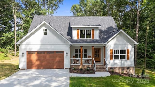 1004 E Sandy Ridge Rd, Monroe, NC 28112 - modern farmhouse featuring a porch, concrete driveway, board and batten siding, and crawl space