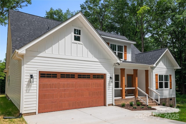 1004 E Sandy Ridge Rd, Monroe, NC 28112 - modern farmhouse style home with board and batten siding, a porch, concrete driveway, and an attached garage