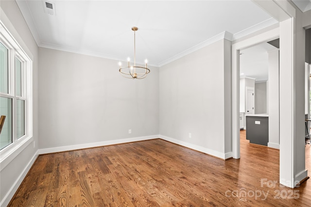 1004 E Sandy Ridge Rd, Monroe, NC 28112 - spare room with a chandelier, crown molding, and wood finished floors