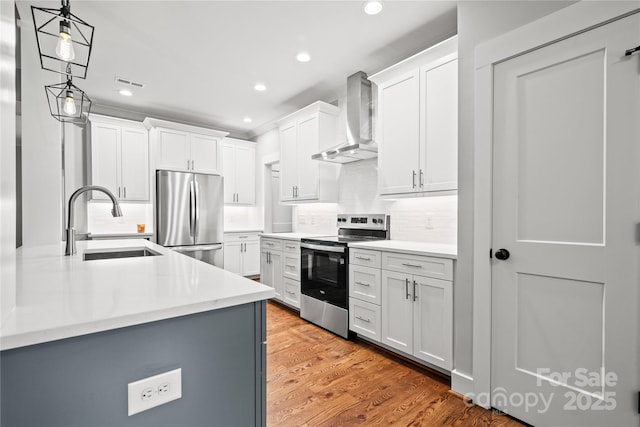 1004 E Sandy Ridge Rd, Monroe, NC 28112 - kitchen with wall chimney range hood, appliances with stainless steel finishes, recessed lighting, light countertops, and decorative backsplash