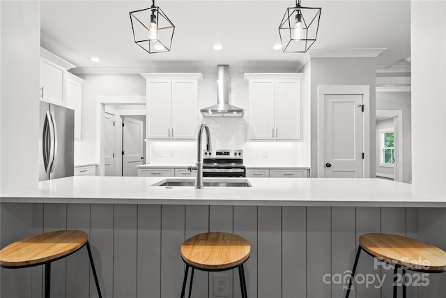 1004 E Sandy Ridge Rd, Monroe, NC 28112 - kitchen with appliances with stainless steel finishes, wall chimney range hood, decorative backsplash, white cabinets, and recessed lighting