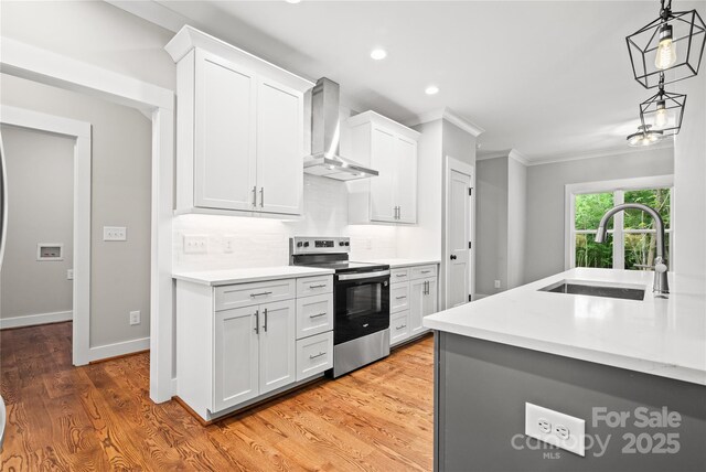 1004 E Sandy Ridge Rd, Monroe, NC 28112 - kitchen featuring stainless steel electric range, wall chimney range hood, crown molding, light countertops, and backsplash