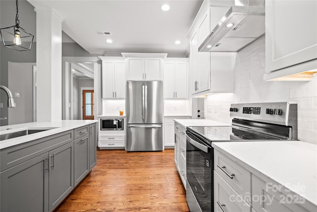 1004 E Sandy Ridge Rd, Monroe, NC 28112 - kitchen with appliances with stainless steel finishes, wall chimney exhaust hood, gray cabinets, light countertops, and white cabinets