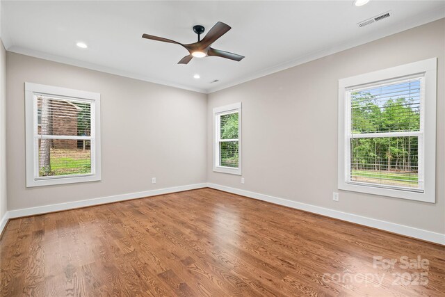 1004 E Sandy Ridge Rd, Monroe, NC 28112 - unfurnished room featuring healthy amount of natural light, ornamental molding, ceiling fan, wood finished floors, and recessed lighting