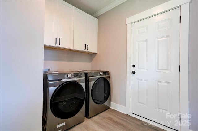 102 Starmount Dr, Kings Mountain, NC 28086 - washroom with cabinet space, separate washer and dryer, crown molding, light wood-style flooring, and baseboards