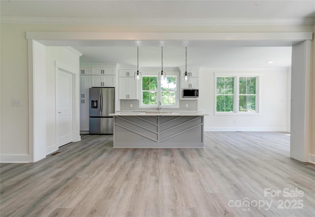 102 Starmount Dr, Kings Mountain, NC 28086 - kitchen featuring stainless steel fridge, a sink, a kitchen island, white cabinets, and light wood-type flooring