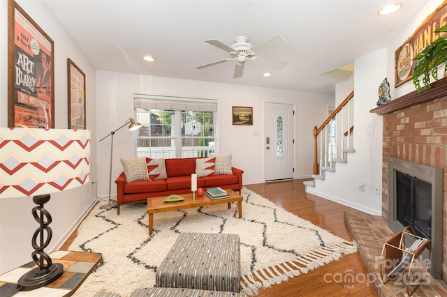 1912 Baxter St, Charlotte, NC 28204 - living room featuring wood finished floors, recessed lighting, ceiling fan, stairway, and a brick fireplace