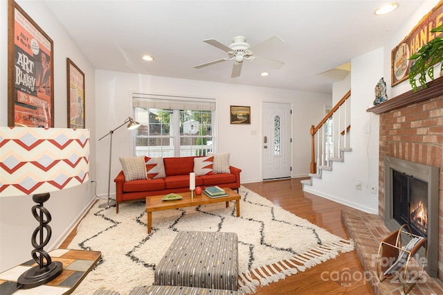 1912 Baxter St, Charlotte, NC 28204 - living room featuring wood finished floors, recessed lighting, ceiling fan, a brick fireplace, and stairway