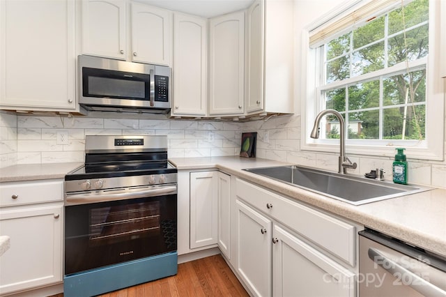 1912 Baxter St, Charlotte, NC 28204 - kitchen featuring appliances with stainless steel finishes, white cabinetry, and light countertops