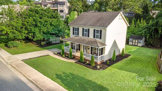 1912 Baxter St, Charlotte, NC 28204 - view of front of house with a porch, roof with shingles, a shed, and a front yard