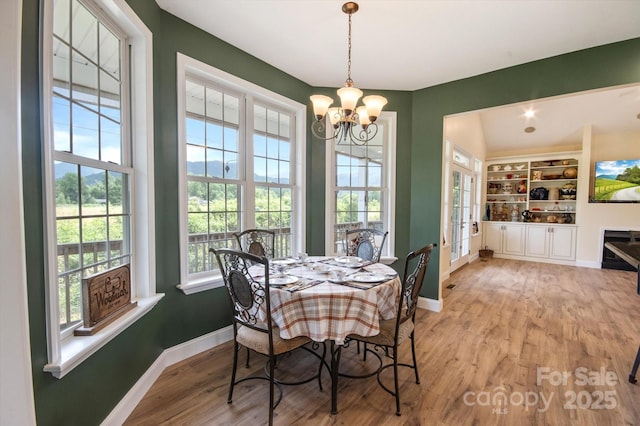 30 Linn Garden Ln, Swannanoa, NC 28778 - dining space with a chandelier, light wood-type flooring, and built in features