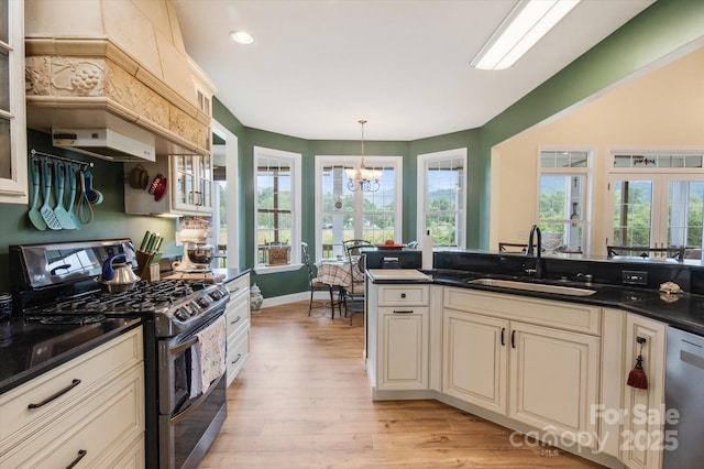 30 Linn Garden Ln, Swannanoa, NC 28778 - kitchen featuring stainless steel appliances, a chandelier, dark countertops, light wood-style floors, and glass insert cabinets