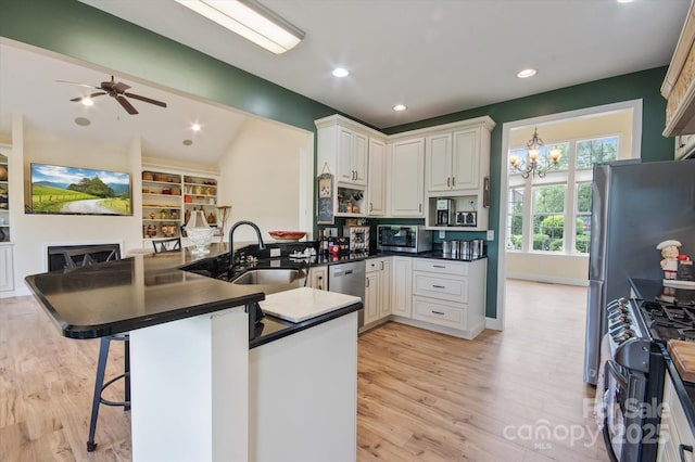 30 Linn Garden Ln, Swannanoa, NC 28778 - kitchen featuring stainless steel appliances, a peninsula, dark countertops, light wood-type flooring, and vaulted ceiling
