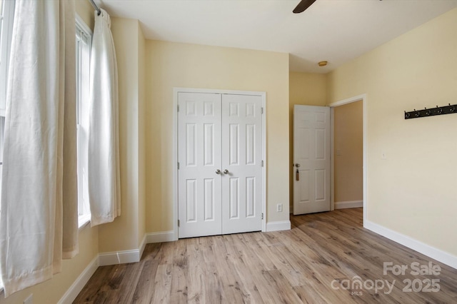 30 Linn Garden Ln, Swannanoa, NC 28778 - unfurnished bedroom featuring a closet, wood finished floors, and a ceiling fan