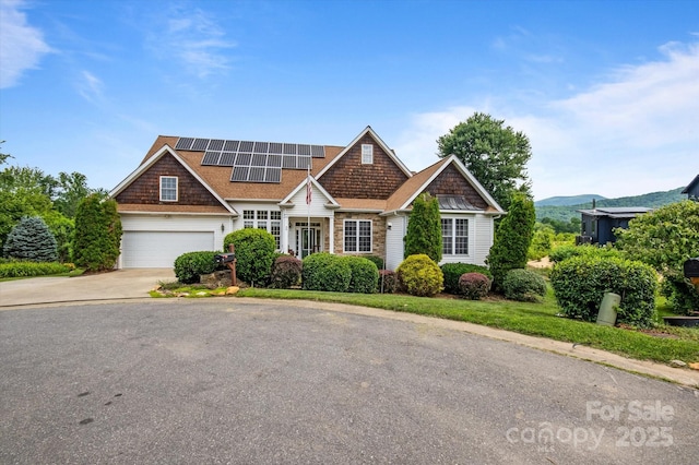 30 Linn Garden Ln, Swannanoa, NC 28778 - view of front of property with solar panels, driveway, stone siding, and a mountain view