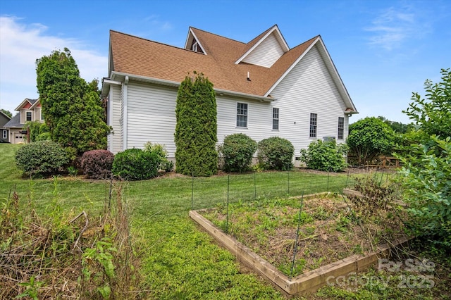 30 Linn Garden Ln, Swannanoa, NC 28778 - view of home's exterior featuring a vegetable garden, roof with shingles, and a yard