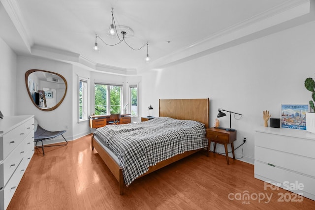 415 N Church St Unit 311, Charlotte, NC 28202 - bedroom with a tray ceiling, light wood-style flooring, crown molding, and a chandelier
